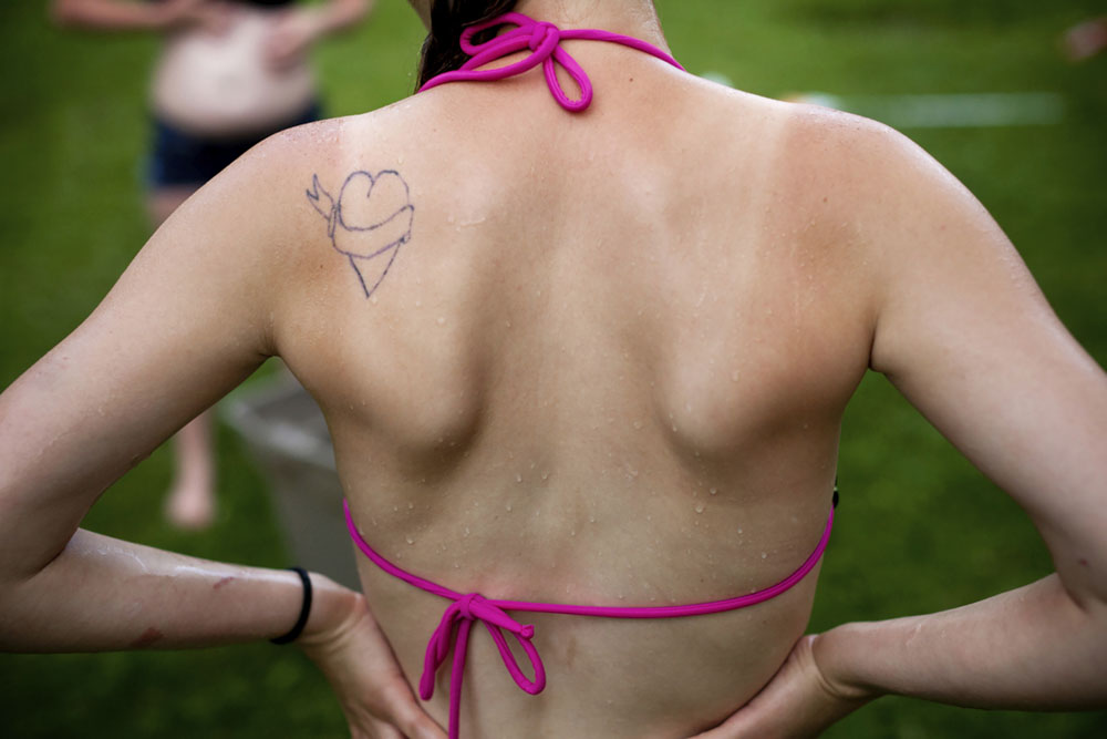 An empty heart is tattooed on Brittney's back.